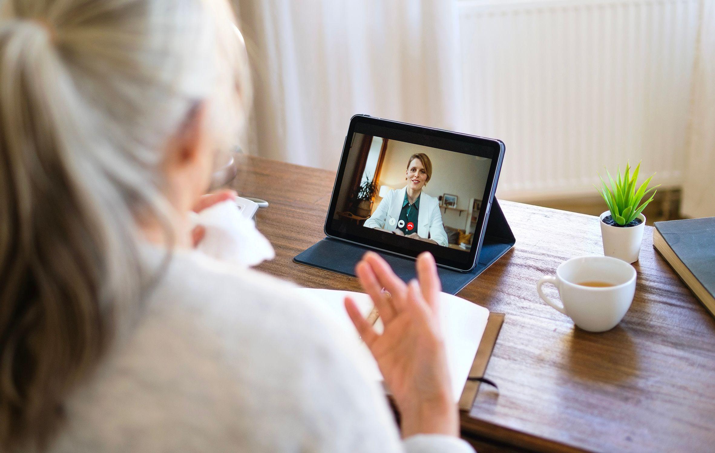 Menopausal woman meeting with a menopause-trained clinician during a telehealth consult