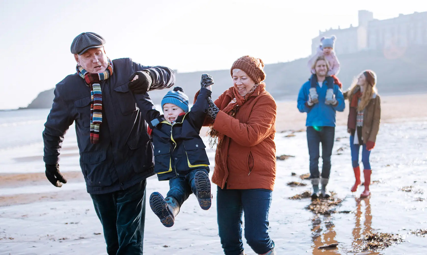 Three generations of a family spending time together. Woman in perimenopause balances caring for young child and aging parents