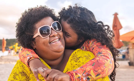 a girl happily hugging her mother who has her menopause travel kit for their trip