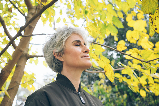 woman takes time in nature for menopause self-care and considers a holistic approach to perimenopause