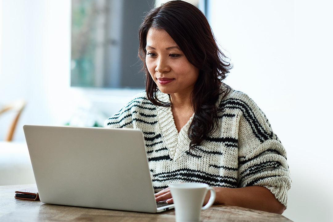 woman on her laptop reading about menopause concentration and cognitive function