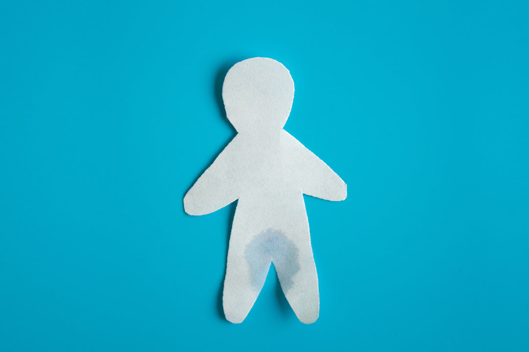 paper cutout of a person with a wet spot to show menopause incontinence