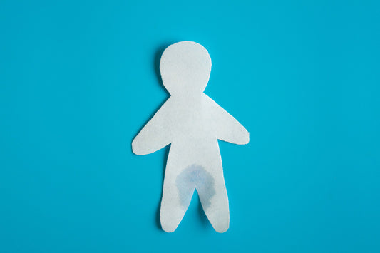 paper cutout of a person with a wet spot to show menopause incontinence