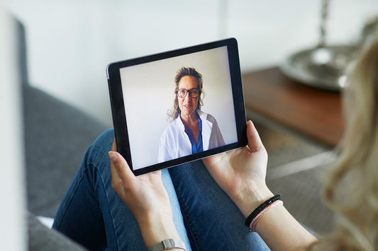 Woman meeting a menopause-trained clinician during a virtual telehealth visit to discuss her menopause symptoms