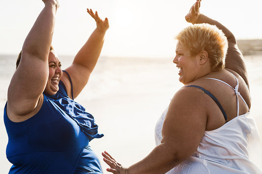 Two perimenopausal women enjoying the beach and boosting their self-care