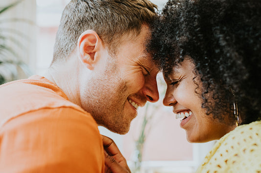 a couple smiling and talking about how to treat vaginal dryness to help them continue enjoying sex during menopause