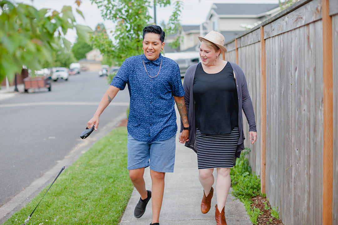 Gender diverse couple spends time together taking a walk while talking about their experiences of menopause