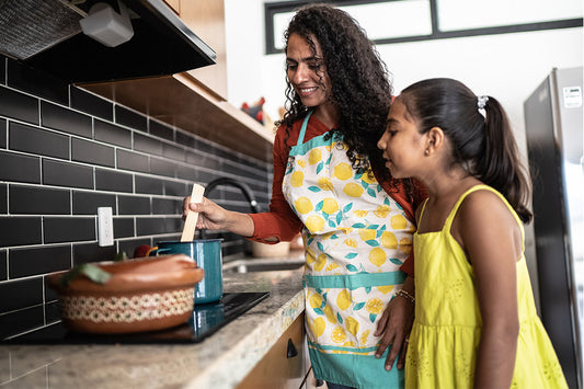 a mother and young daughter cooking together and discussing the hormonal changes they're both experiencing