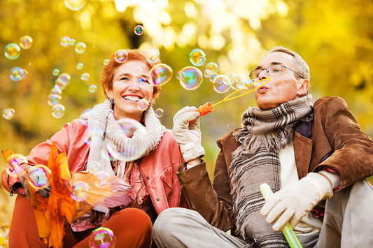 a woman dating during menopause, playing bubble blowing with a man