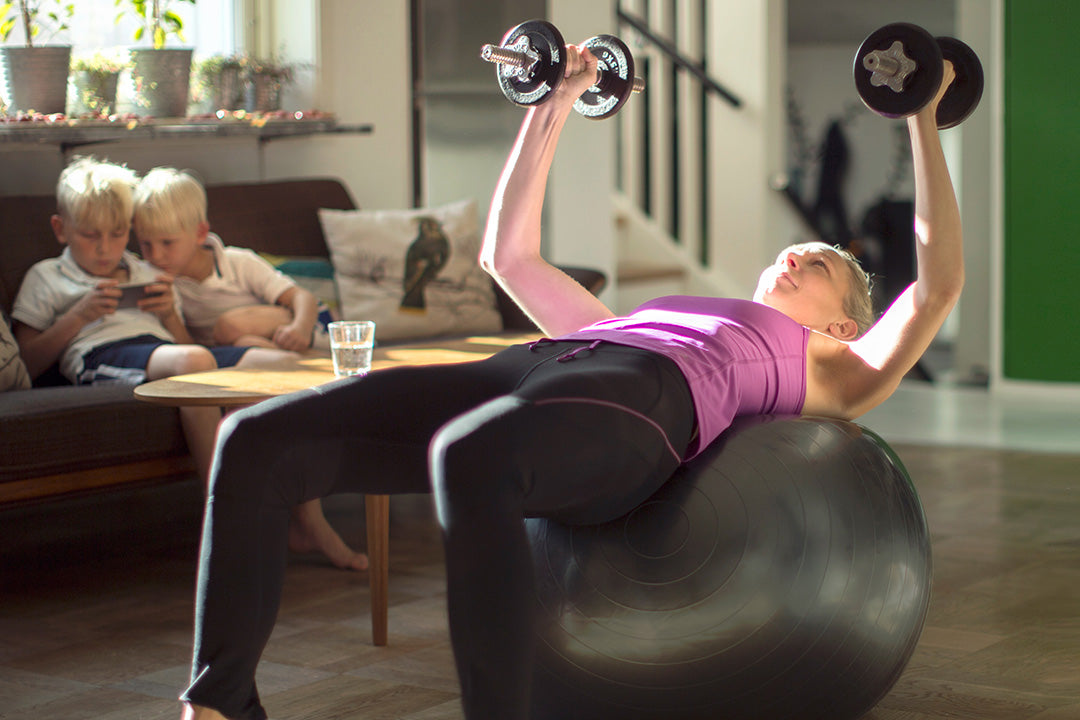 Perimenopause women strength training in her home to help boost metabolism and maintain weight