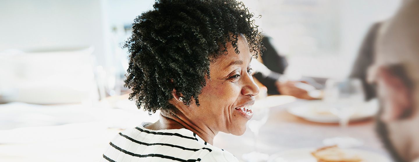 woman smiling and talking about her menopause skin care routine to help her look and feel her best