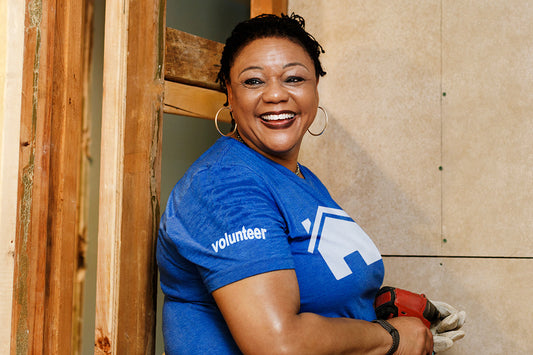 woman experiencing menopause symptoms finds a volunteer opportunity to help build homes in a non-profit organization