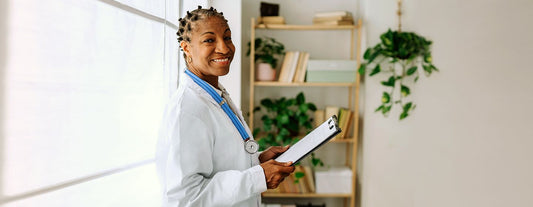 menopause doctor smiling with a clipboard in her hand