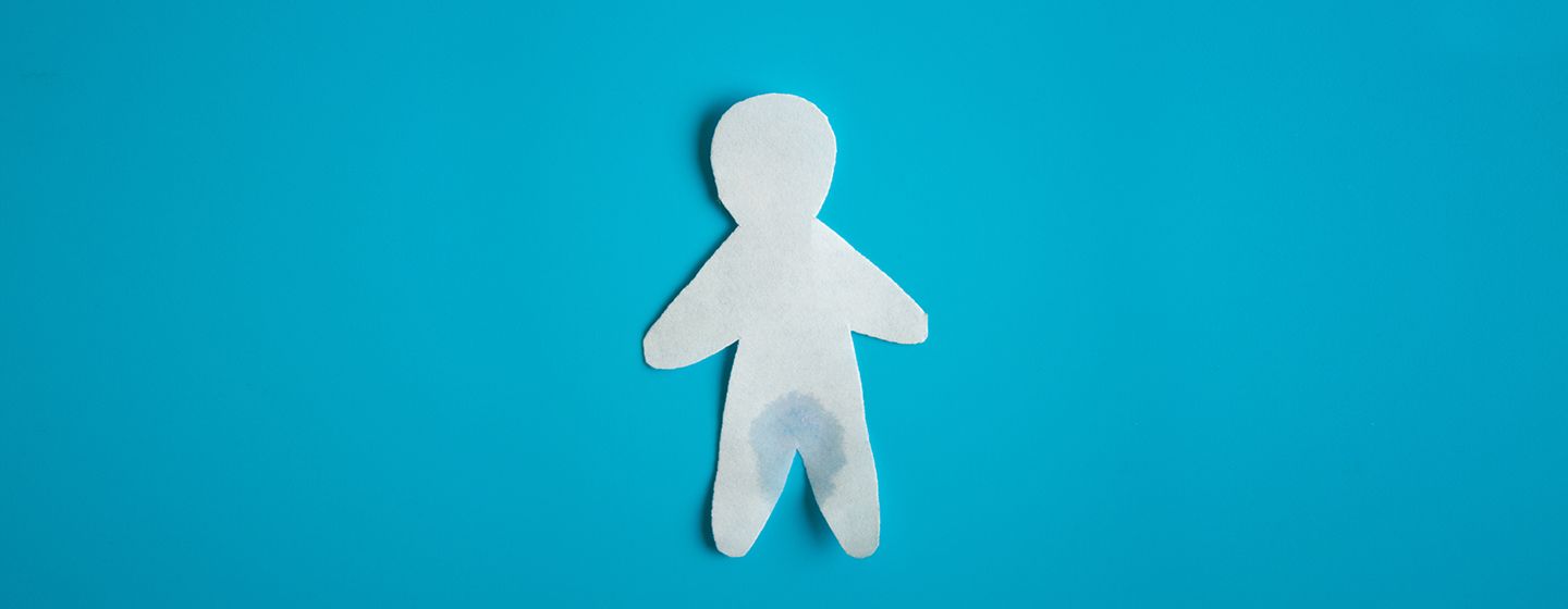 paper cutout of a person with a wet spot to show menopause incontinence