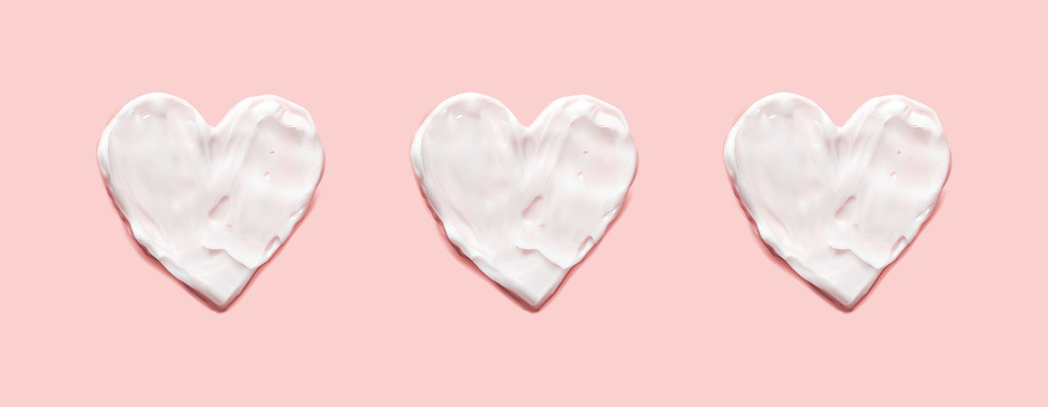 Three white hearts on a pink background to represent menopause and heart health