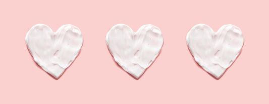 Three white hearts on a pink background to represent menopause and heart health