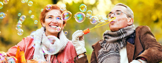 a woman dating during menopause, playing bubble blowing with a man