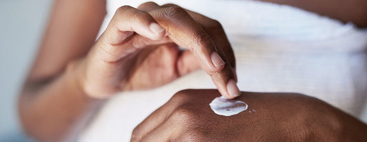 a woman applying hydrating cream onto her hands to soothe her itchy skin caused by menopause