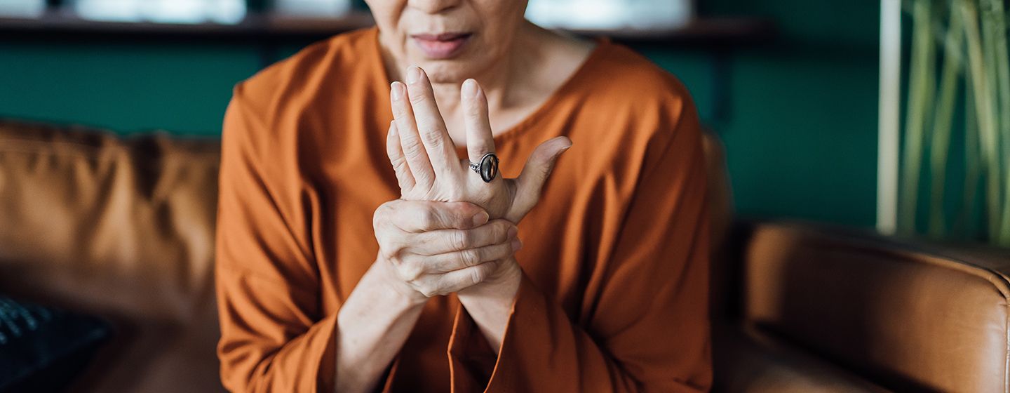 woman experiencing joint stiffness in her hand and finding options to relieve menopause joint pain