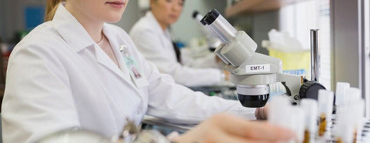 a woman in a lab testing a patient's blood for menopausal indicators such as FSH, LH & AMH levels