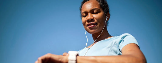 woman looking at her watch as she prepares to go on a run to maintain a healthy weight during menopause