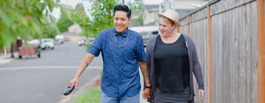 Gender diverse couple spends time together taking a walk while talking about their experiences of menopause