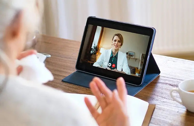 Menopausal woman meeting with a menopause-trained clinician during a virtual care telehealth visit