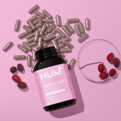 HUM NUTRITION Private Party capsules scattered next to bottle and several ingredients