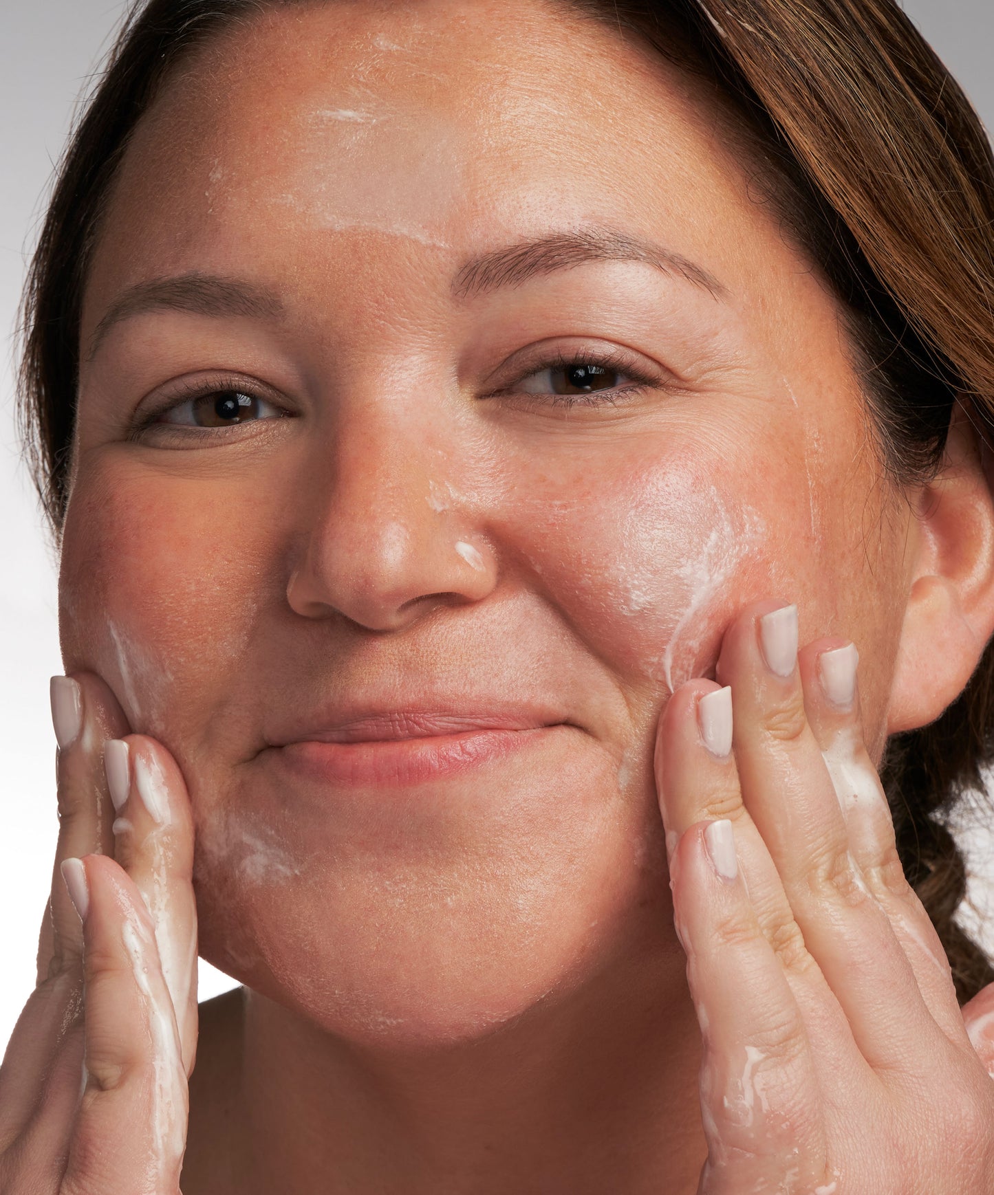 person putting NEOSTRATA Restore PHA Facial Cleanser Gentle Gel Facial Wash on their face