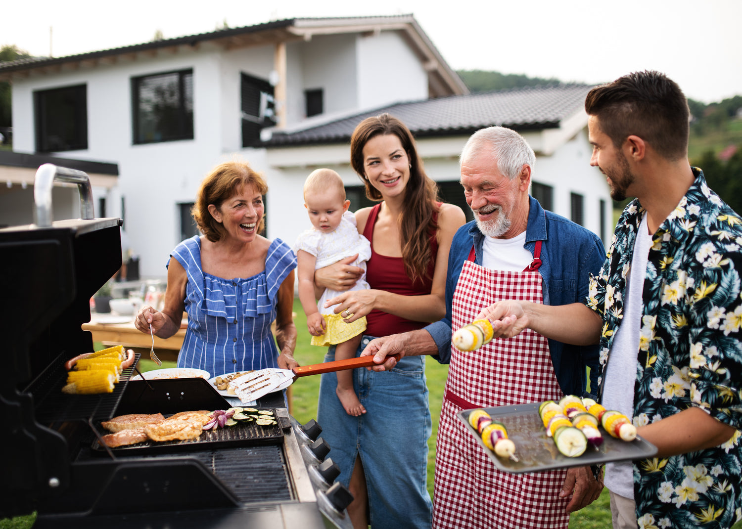 multigenerational family celebrating summer foods and grilling together